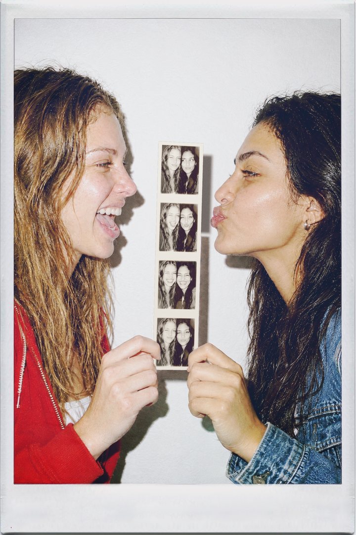 IncrediBooth, profile: two friends holding up a photo booth strip